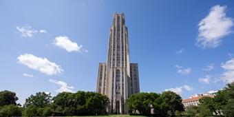 Cathedral of Learning from a distance, against blue sky